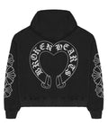Back of a black Broken Hearts boxy hoodie with jumbo white horseshoe heart print and daisy floral sleeve panels
